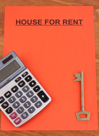 Advertise rental houses on red paper on wooden backgroundの写真素材