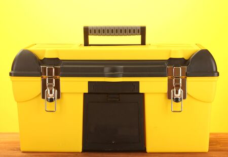 yellow tool box on yellow background close-upの写真素材