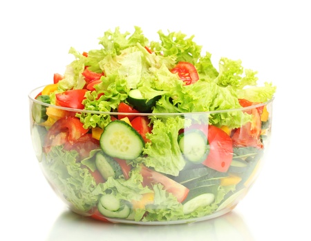 fresh vegetable salad in transparent bowl isolated on whiteの写真素材