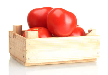 Ripe red tomatoes in wooden box isolated on whiteの写真素材
