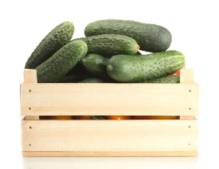 fresh cucumbers in wooden box  isolated on whiteの写真素材