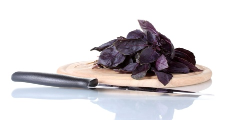 Basil on a cutting board isolated on white