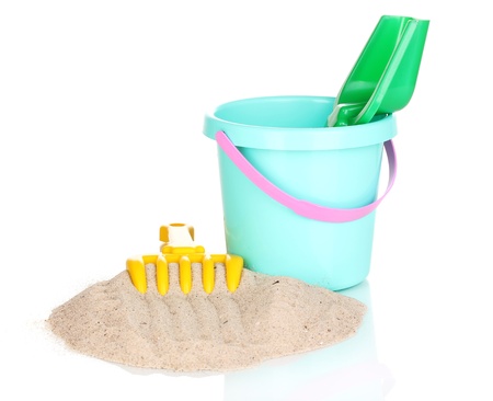 Children's beach toys and sand isolated on whiteの写真素材