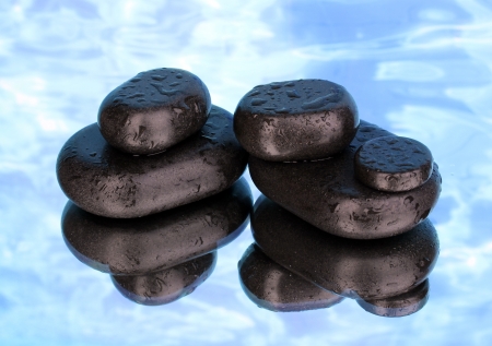 Spa stones with droplets on blue backgroundの写真素材
