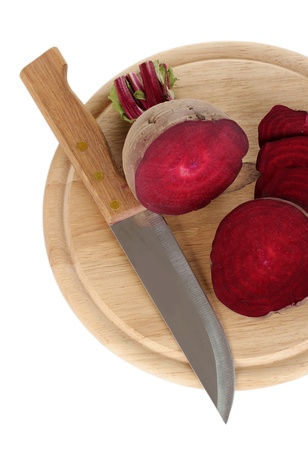 Young red beet and knife on wooden board isolated on whiteの写真素材