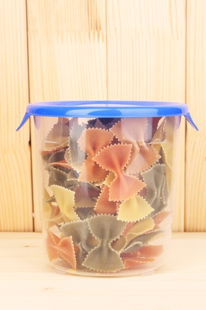 Filled plastic container on wooden backgroundの写真素材