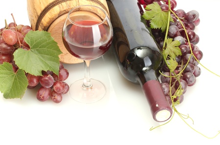barrel, bottles and glass of wine and ripe grapes isolated on whiteの写真素材