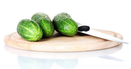 Cucumbers on a cutting board isolated on whiteの写真素材