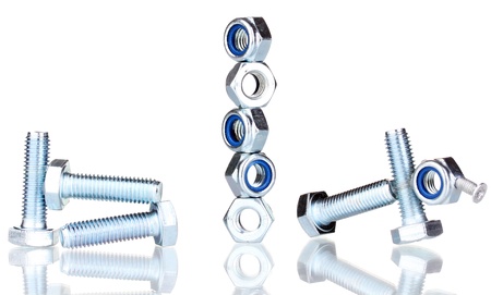 Stacks of balanced screws and screw-nuts isolated on white