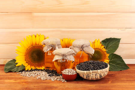 sunflower oil and sunflower on wood backgroundの写真素材