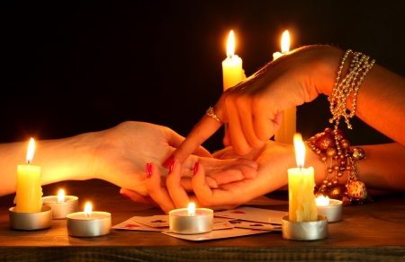 reading the lines hand in a woman's hands on black backcgroundの写真素材