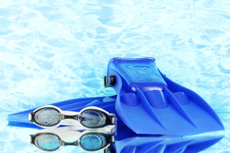 blue flippers and goggles on blue sea backgroundの写真素材