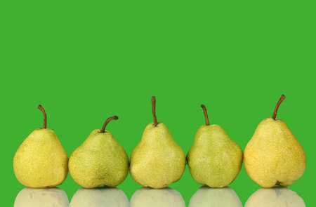 Ripe pears on bright green backgroundの写真素材