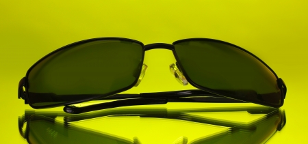 Sunglasses on green background