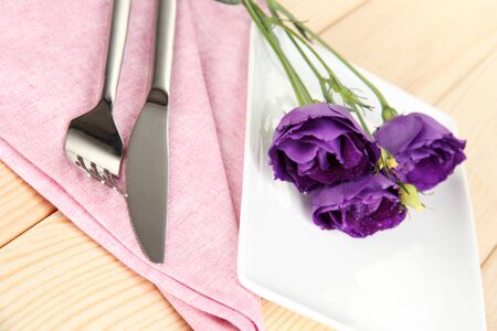 Tableware with flower on bright napkin close-upの写真素材