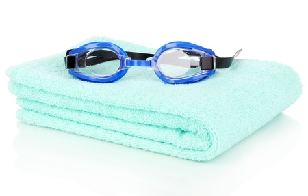 Swim goggles on towel isolated on whiteの写真素材