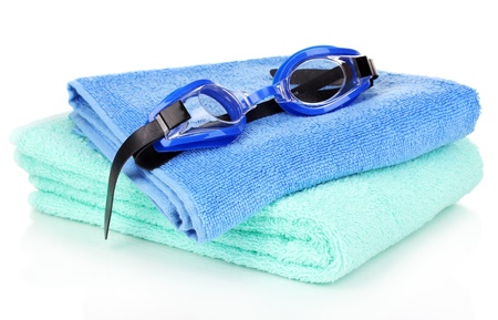 Swim goggles on towel isolated on whiteの写真素材