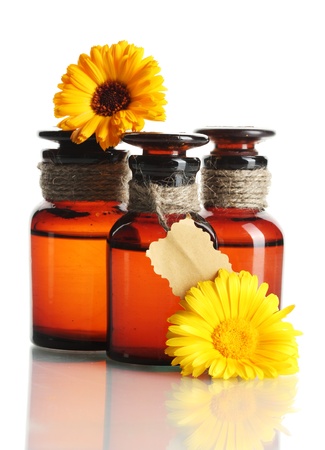 medicine bottles and beautiful calendula flowers, isolated on whiteの写真素材