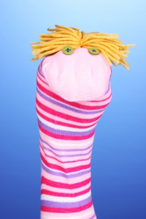 Cute sock puppet on blue backgroundの写真素材