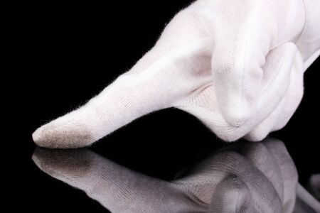 Auditor hand checking cleanliness isolated on blackの写真素材