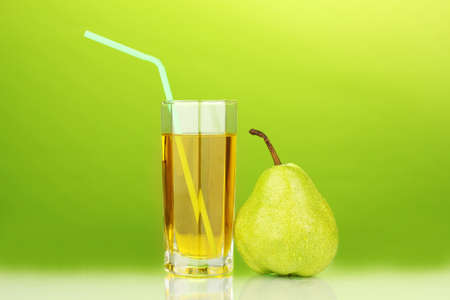 Pear juice in a glass on green backgroundの写真素材