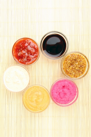 various sauces on bamboo matの写真素材