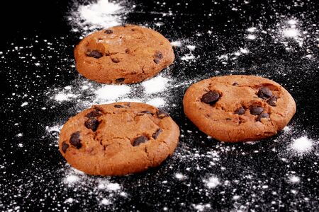 Chocolate chips cookies isolated on blackの写真素材