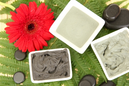cosmetic clay for spa treatments on straw background close-upの写真素材