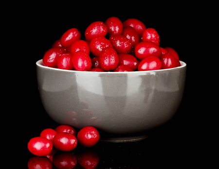 fresh cornel berries in bowl isolated on white