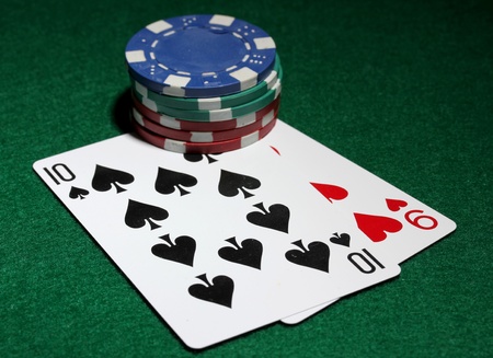 Cards and chips for poker on green table