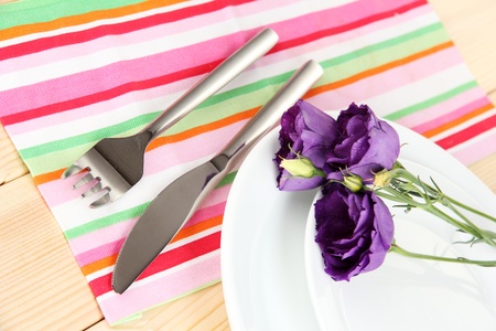 Tableware with flower on bright napkin close-upの写真素材