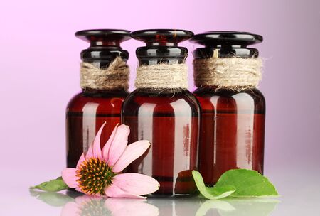 medicine bottles with purple echinacea, on pink backgroundの写真素材