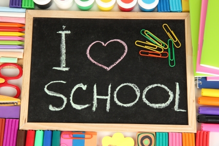 Small school desk with various school supplies close-up isolated on whiteの写真素材