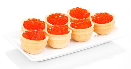 Red caviar in tartlets on white plate isolated on whiteの写真素材