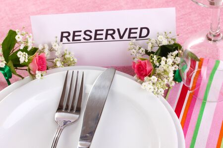 Table setting with reserved card in restaurant