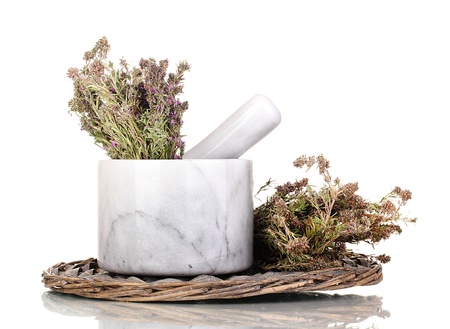 Thyme herb and mortar on wicker mat isolated on whiteの写真素材