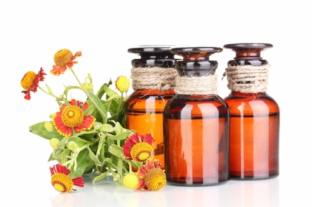 medicine bottles and flowers isolated on whiteの写真素材
