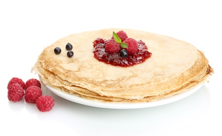 Delicious pancakes with berries and jam on plate isolated on whiteの写真素材