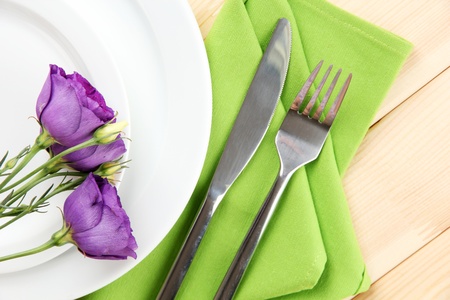 Tableware with flower on bright napkin close-upの写真素材
