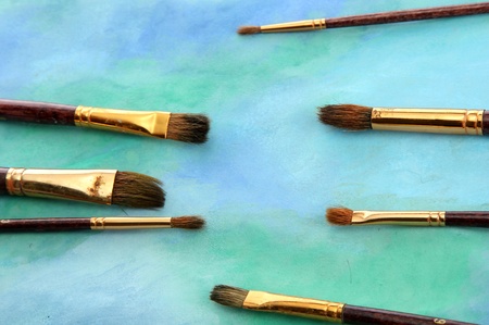 brushes on bright abstract gouache painted backgroundの写真素材