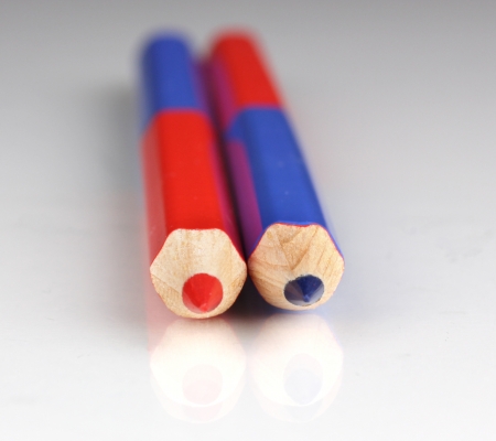 Red and blue pencils close-up isolated on whiteの写真素材