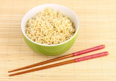 asian noodles in bowl on bamboo matの写真素材