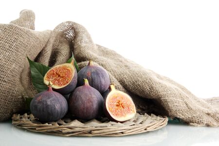 Ripe sweet figs with leaves isolated on whiteの写真素材