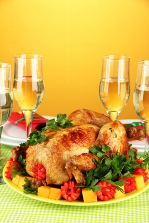 banquet table with roast chicken on orange background close-up. Thanksgiving Dayの写真素材