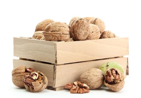 walnuts in woooden crate, isolated on whiteの写真素材