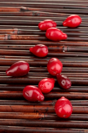 fresh cornel berries on bamboo matの写真素材