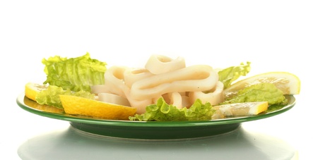salad of squid rings, lemon and lettuce in the plate isolated on whiteの写真素材