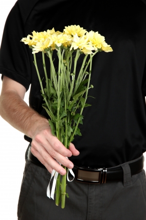 man holding flowers close-upの写真素材