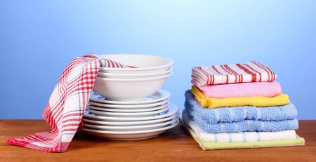 kitchen towels with dishes on blue background close-upの写真素材