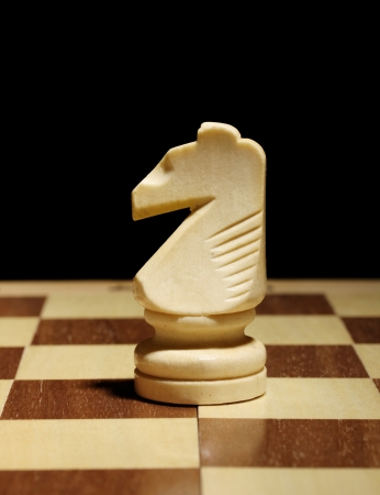 Chess board with chess piece isolated on blackの写真素材